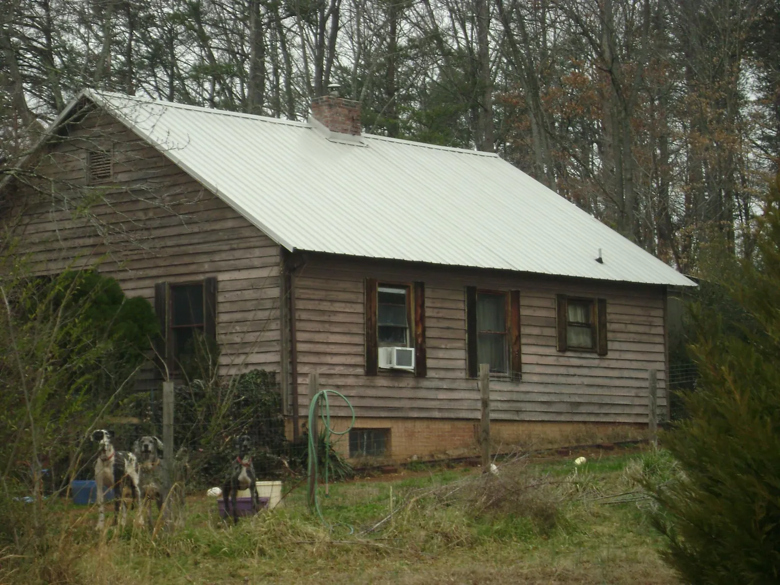 White metal roof on an old wood sided farmhouse, from a Metal Roof Installation job in Earlville